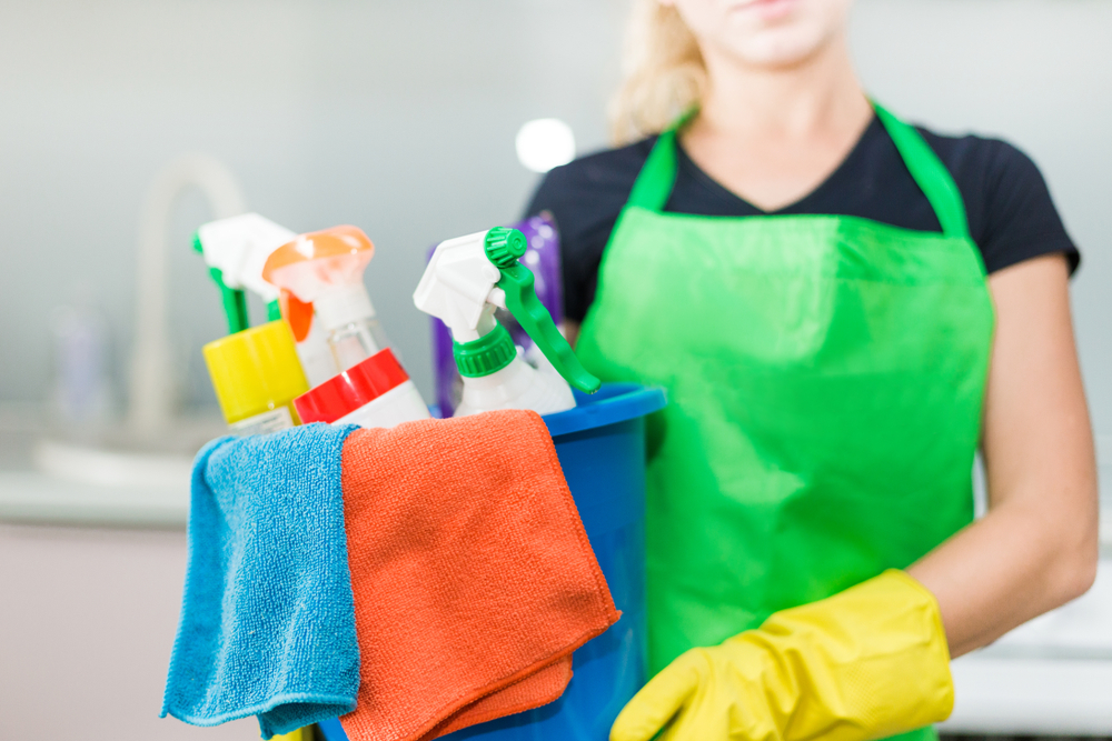 Young,Woman,Holding,Bucket,With,Group,Of,Cleaning,Supplies,For